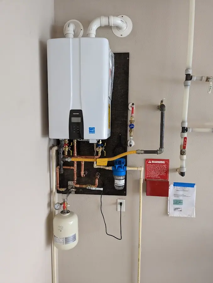 Professional plumber installing copper piping in a Garfield home